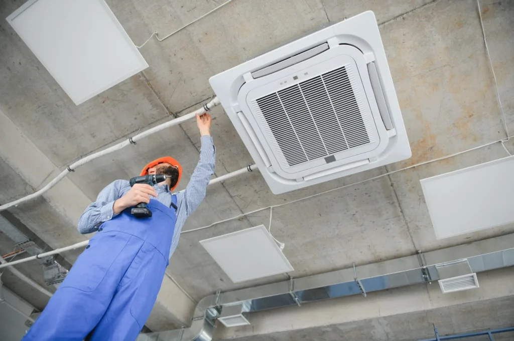 technician repairing air conditioner in New York